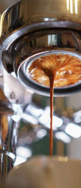 espresso pouring from bottomless portafilter, low angle shot